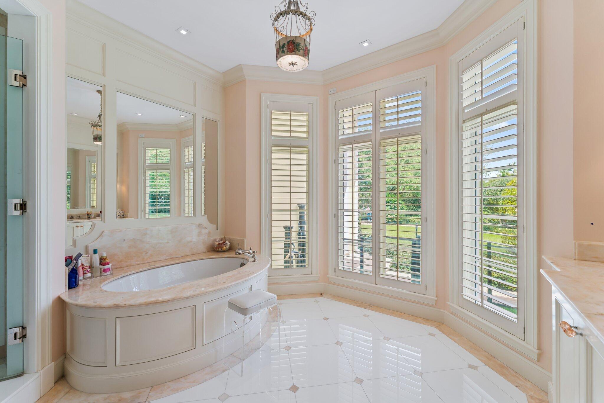 124 Bears Club Drive Jupiter, FL 33477 - Photo 39 of 67 a spacious bathroom with a tub shower and windows