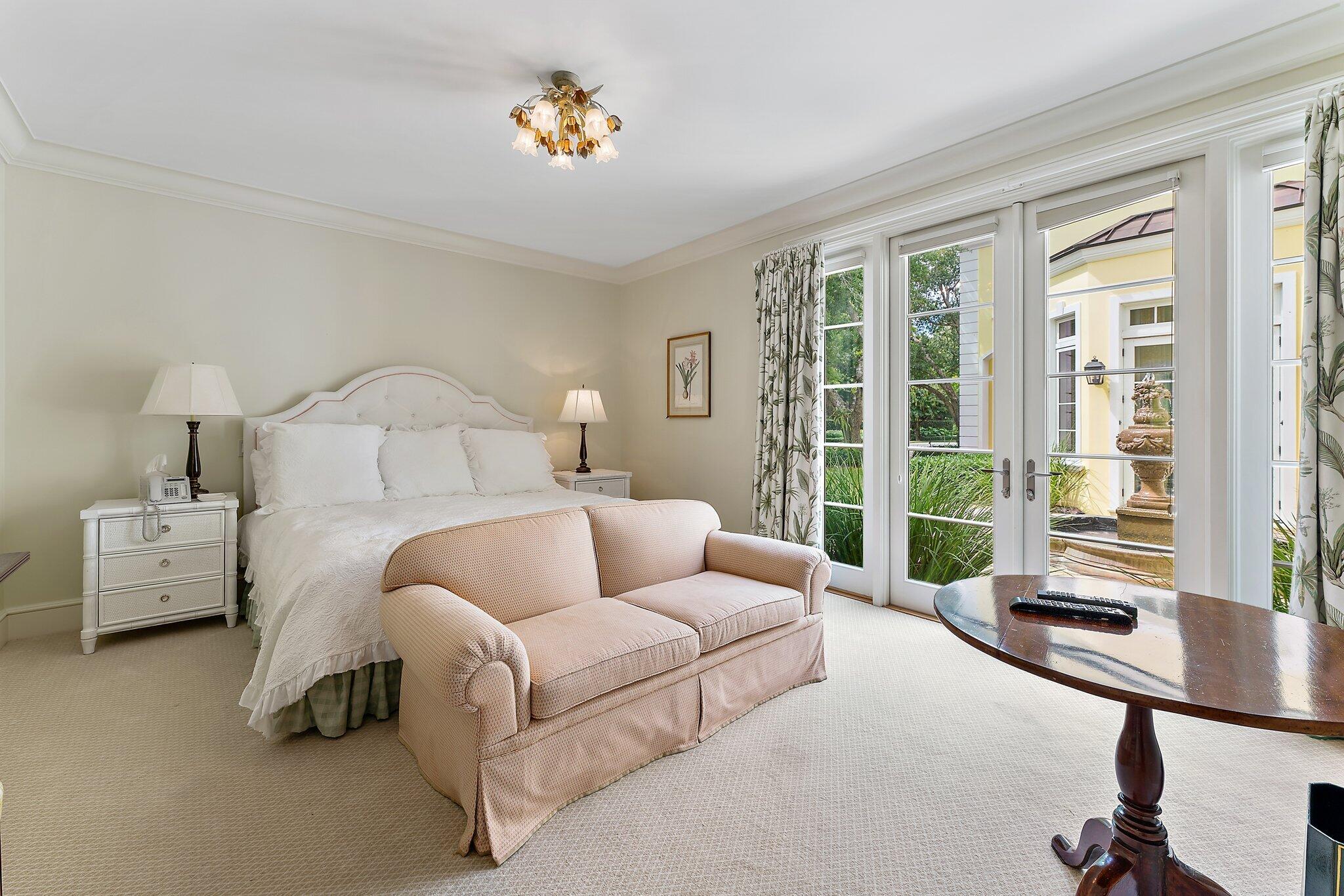 124 Bears Club Drive Jupiter, FL 33477 - Photo 42 of 67 a bedroom with furniture and a large window