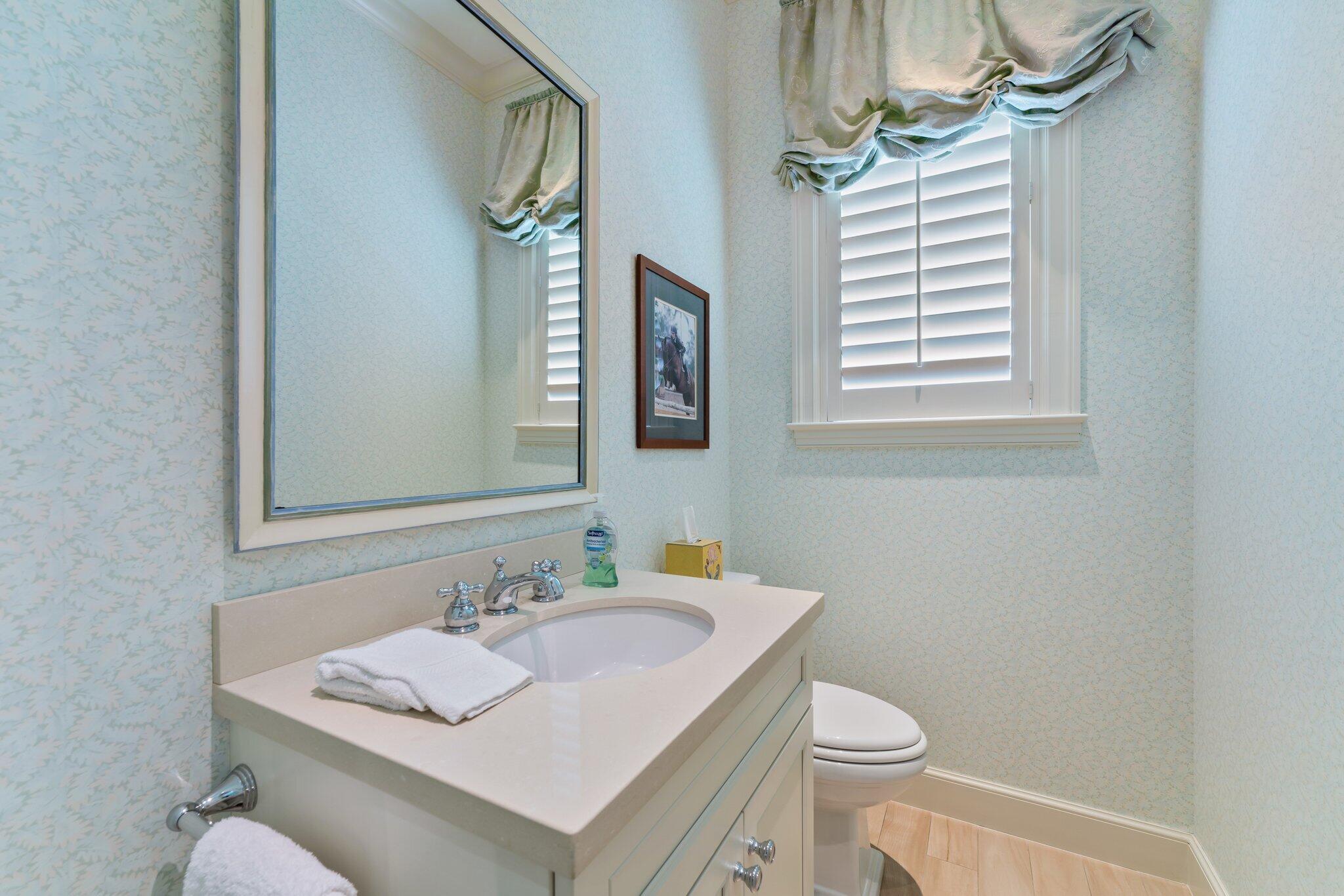 124 Bears Club Drive Jupiter, FL 33477 - Photo 43 of 67 a bathroom with a sink toilet and mirror