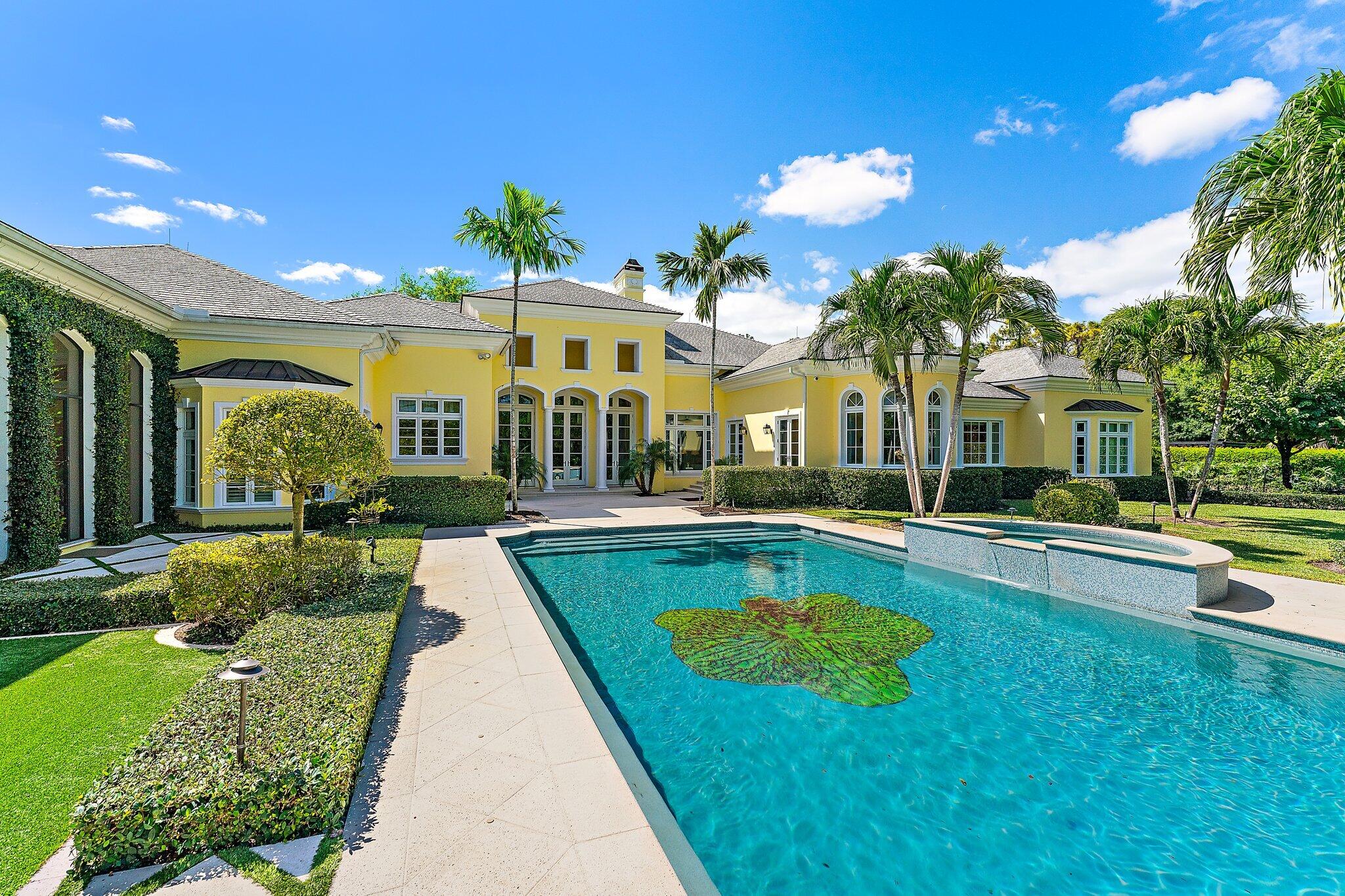 124 Bears Club Drive Jupiter, FL 33477 - Photo 59 of 67 a view of a house with swimming pool and a yard