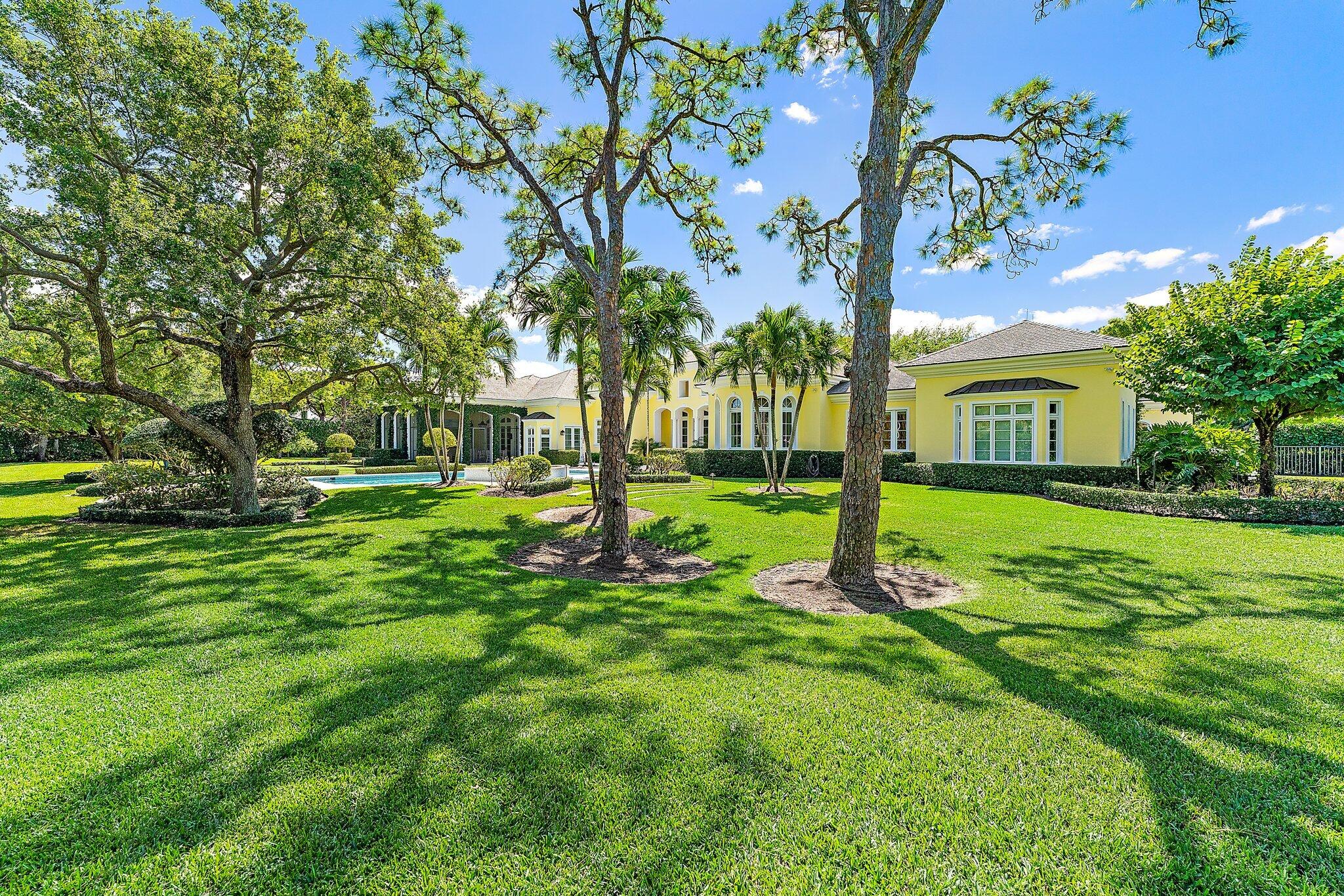 124 Bears Club Drive Jupiter, FL 33477 - Photo 60 of 67 a view of a house with a backyard