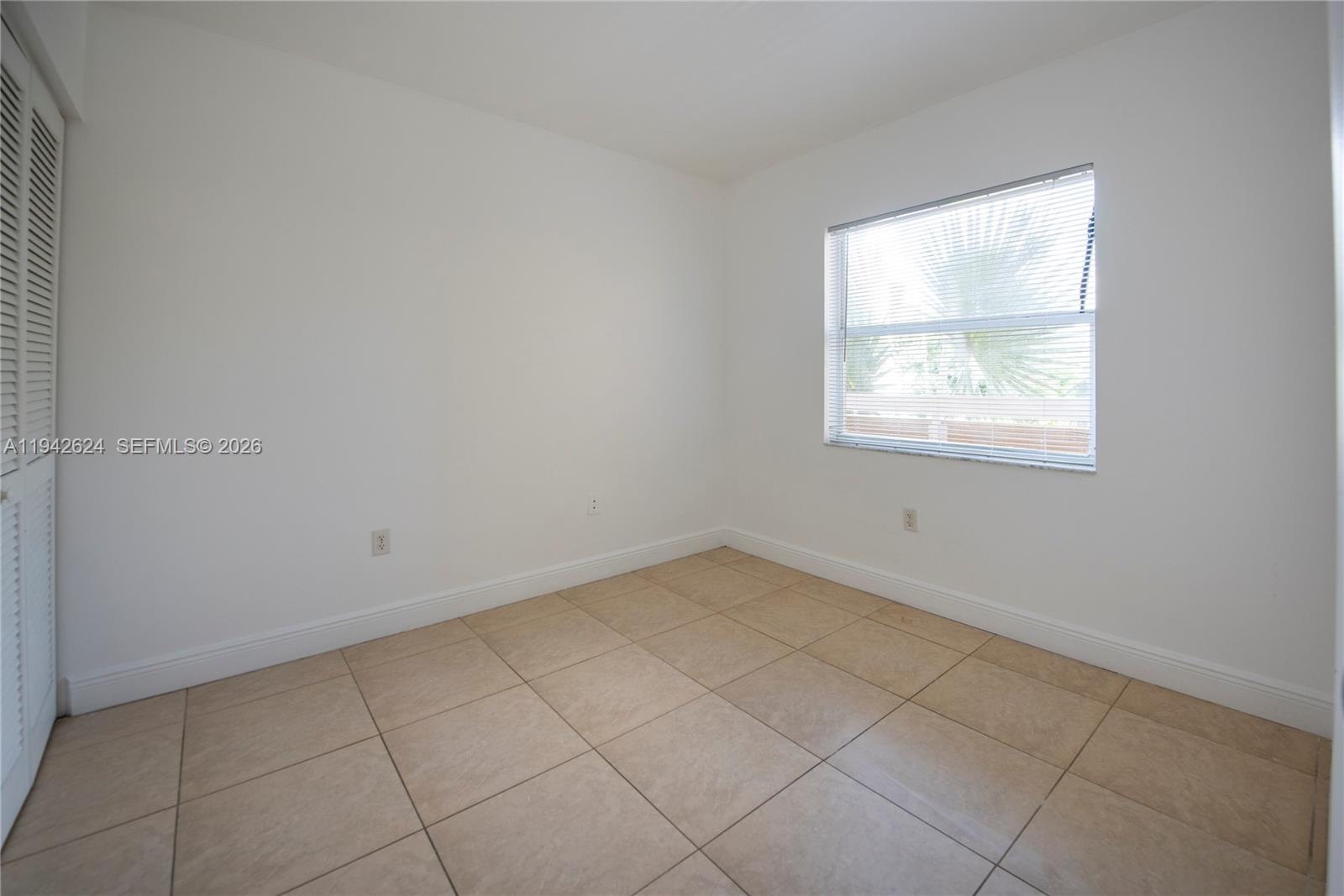 4137 Stirling Road, Unit 506 Dania Beach, FL 33314 - Photo 12 of 13 an empty room with a window