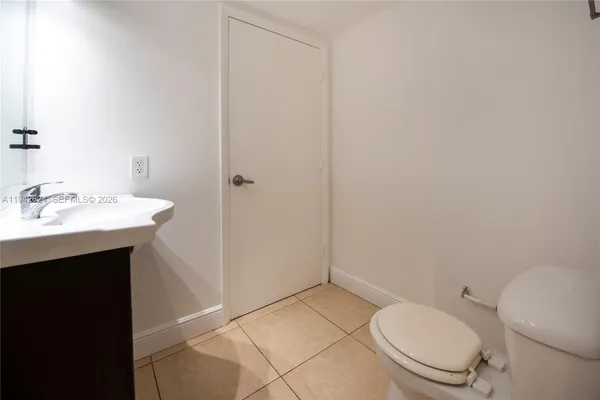 a bathroom with a toilet a sink and mirror