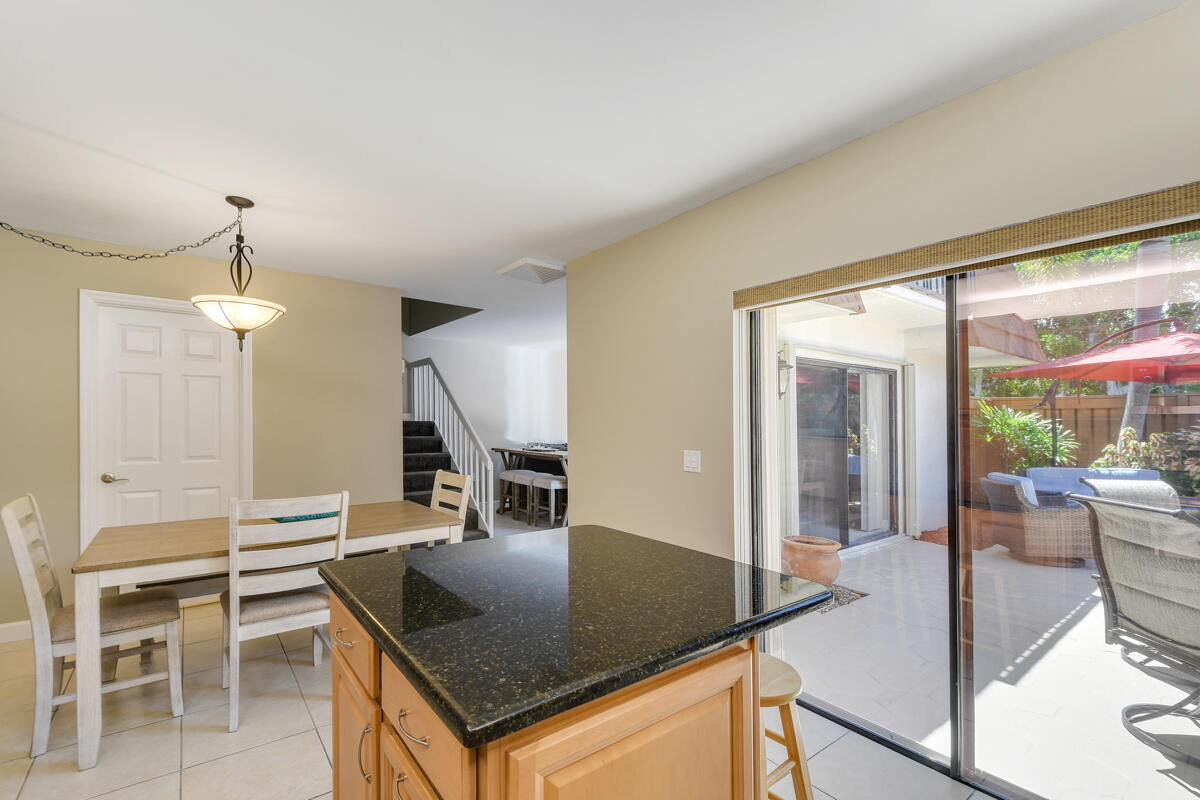 3900 County Line Road, Unit 9D Tequesta, FL 33469 - Photo 16 of 34 a kitchen with dining table and chairs