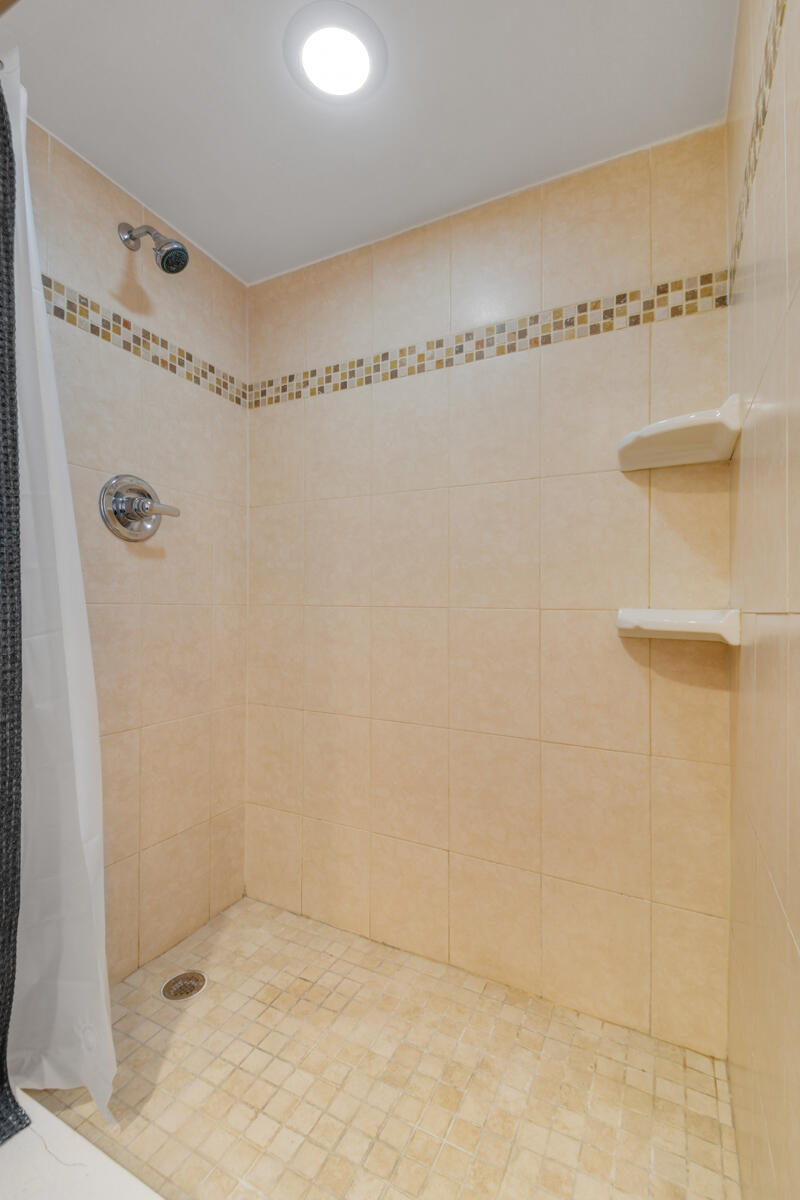 3900 County Line Road, Unit 9D Tequesta, FL 33469 - Photo 24 of 34 a bathroom with a shower
