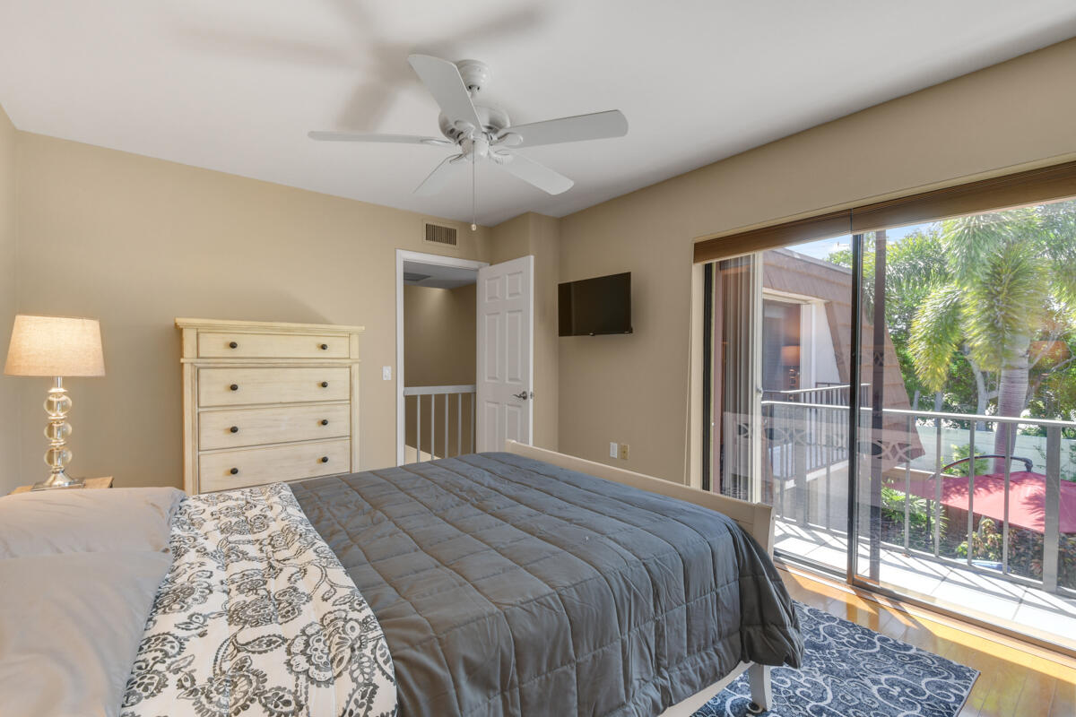 3900 County Line Road, Unit 9D Tequesta, FL 33469 - Photo 26 of 34 a bedroom with a large bed and a tv