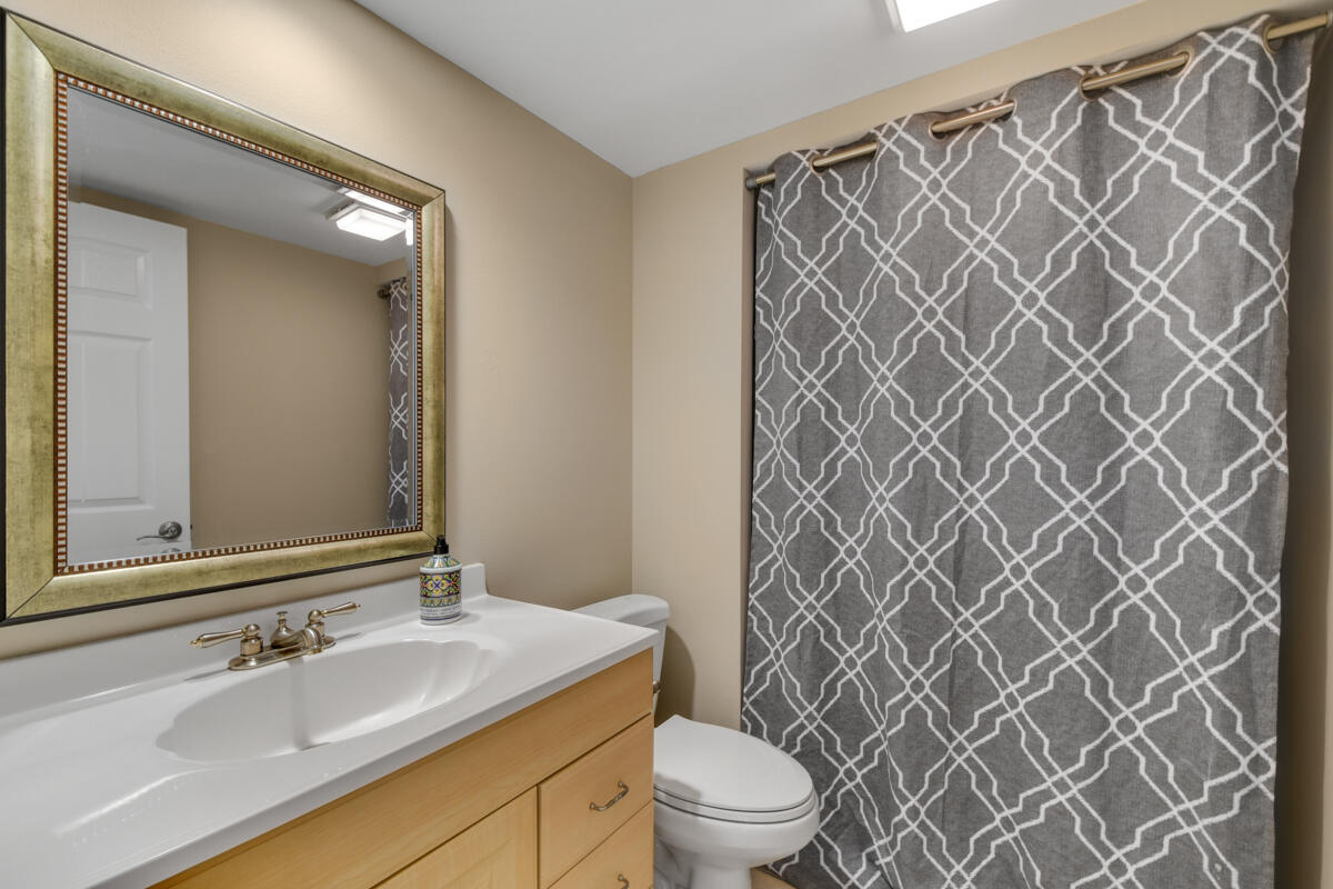 3900 County Line Road, Unit 9D Tequesta, FL 33469 - Photo 29 of 34 a bathroom with a sink mirror vanity and toilet