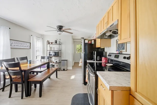 a kitchen with a stove a refrigerator and a sink