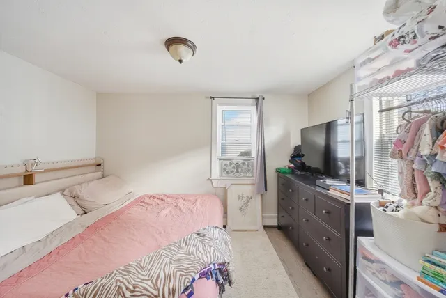 a bedroom with a bed and chair