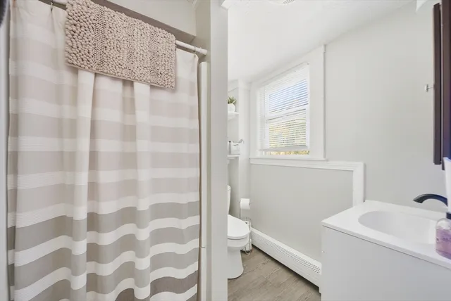 a bathroom with a sink a toilet and a mirror