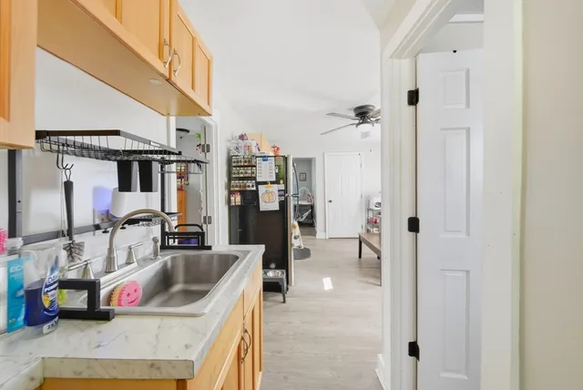 a view of a refrigerator with wooden floor and windows