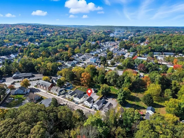 an aerial view of a house with a yard