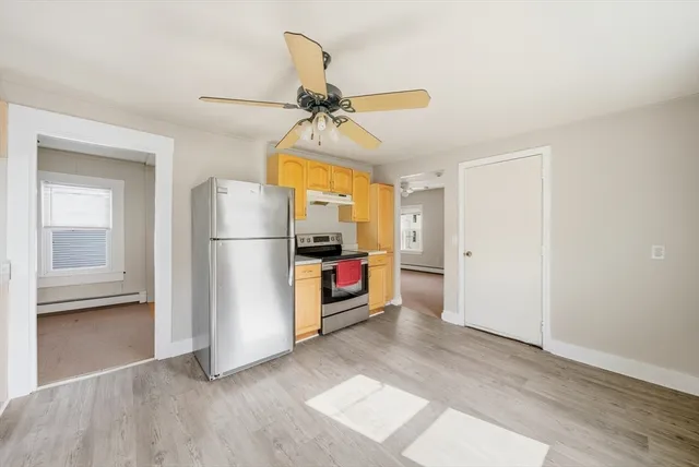 a view of entryway with kitchen and a window