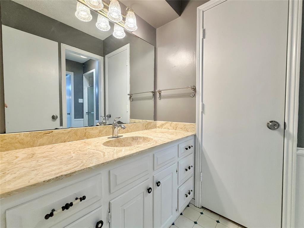 1821 Broadway Street Denton, TX 76201 - Photo 12 of 21 a bathroom with a granite countertop sink and a mirror