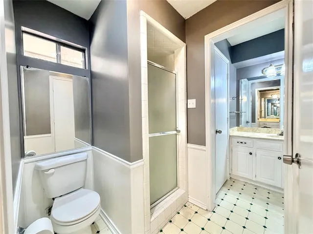 a bathroom with a toilet sink and a mirror