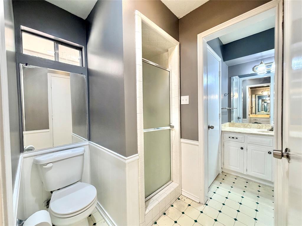 1821 Broadway Street Denton, TX 76201 - Photo 13 of 21 a bathroom with a toilet sink and a mirror