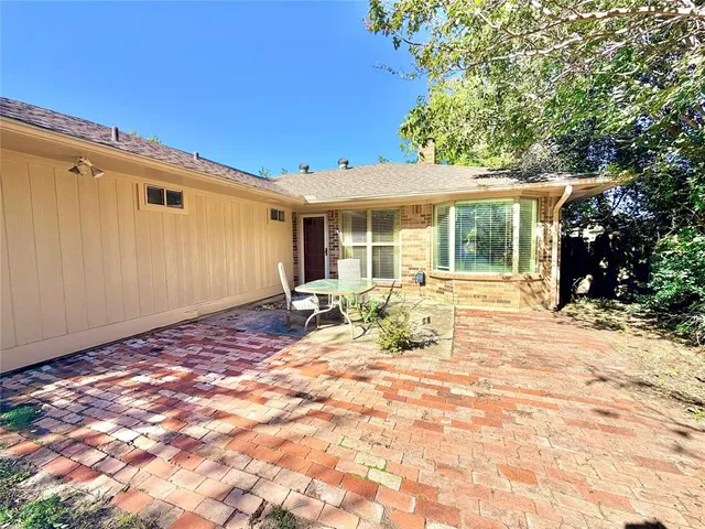a view of a backyard with a patio