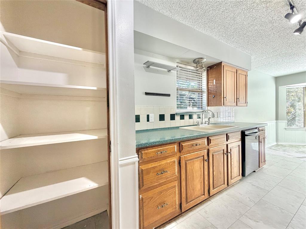 1821 Broadway Street Denton, TX 76201 - Photo 8 of 21 a kitchen with granite countertop a sink