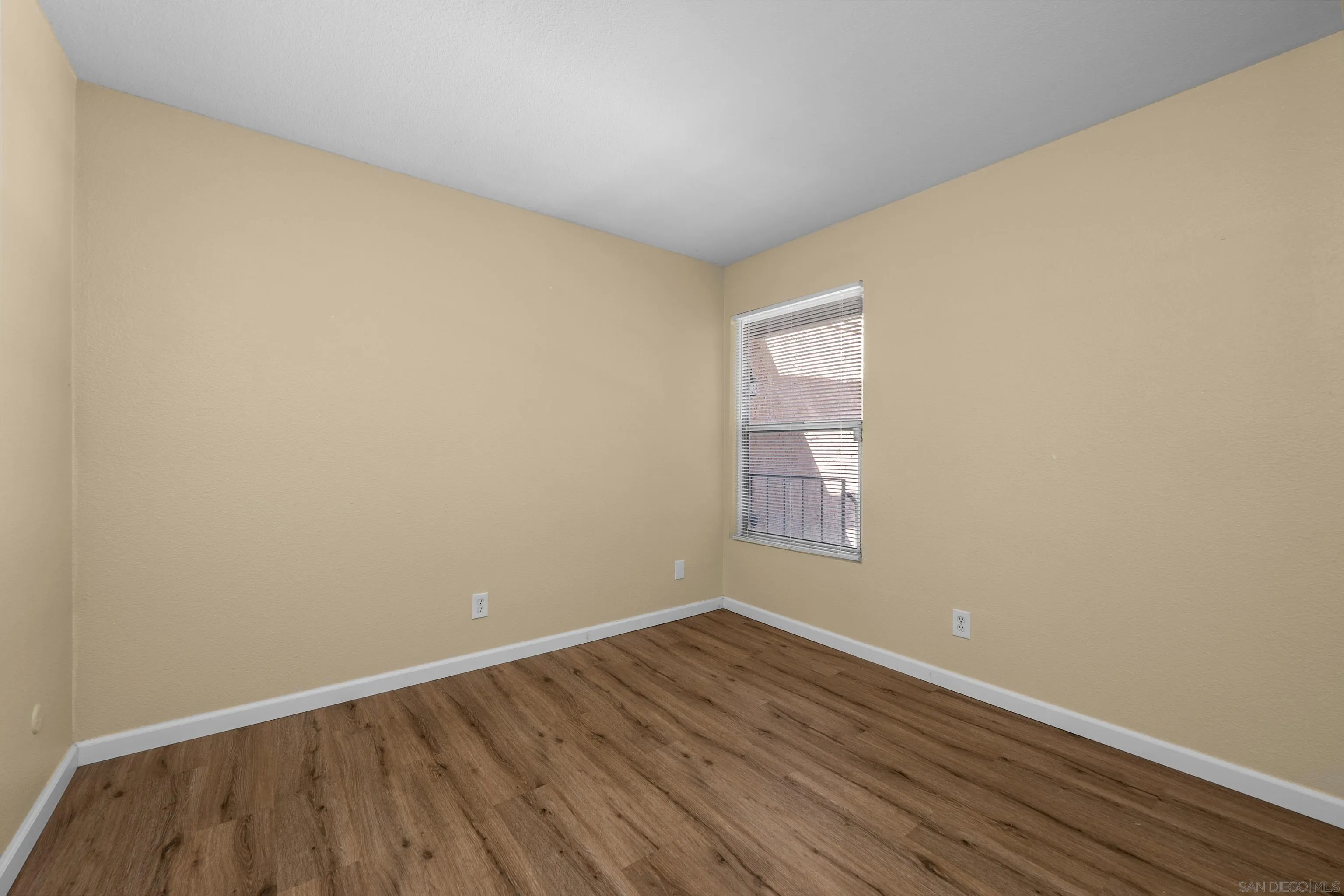 6911 Alvarado Road, Unit 20 San Diego, CA 92120 - Photo 12 of 28 an empty room with wooden floor and windows