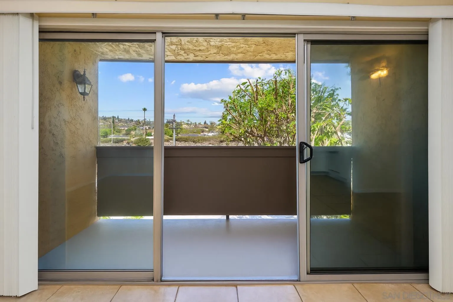 6911 Alvarado Road, Unit 20 San Diego, CA 92120 - Photo 18 of 28 a view of a glass door of the house