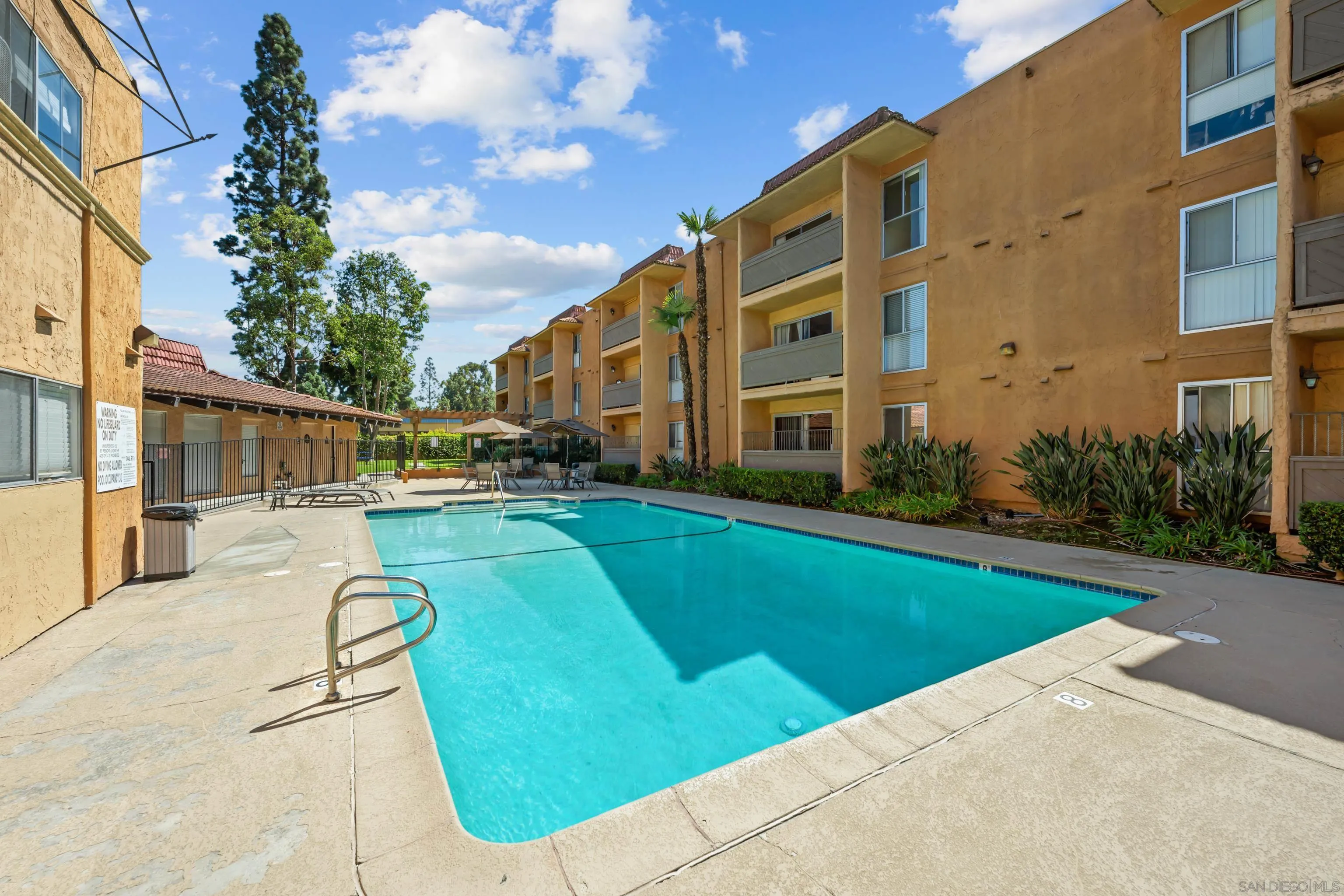 6911 Alvarado Road, Unit 20 San Diego, CA 92120 - Photo 21 of 28 a view of a swimming pool with a patio