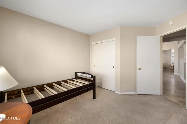 a room with a bench and white walls