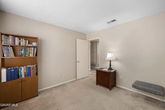 a living room with furniture and a lamp