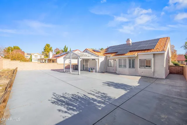 a view of a white house with a yard