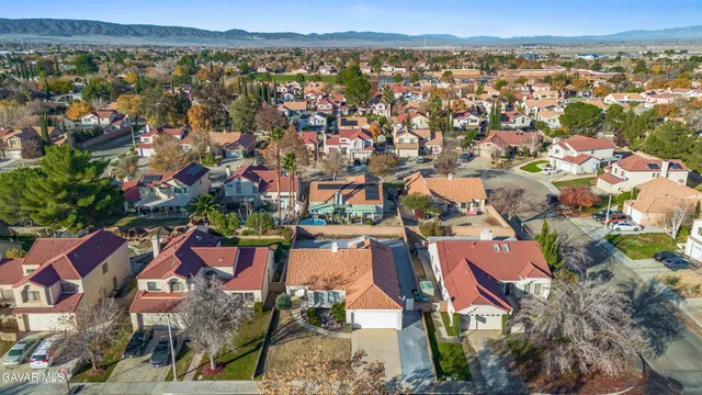 an aerial view of residential houses with outdoor space and river