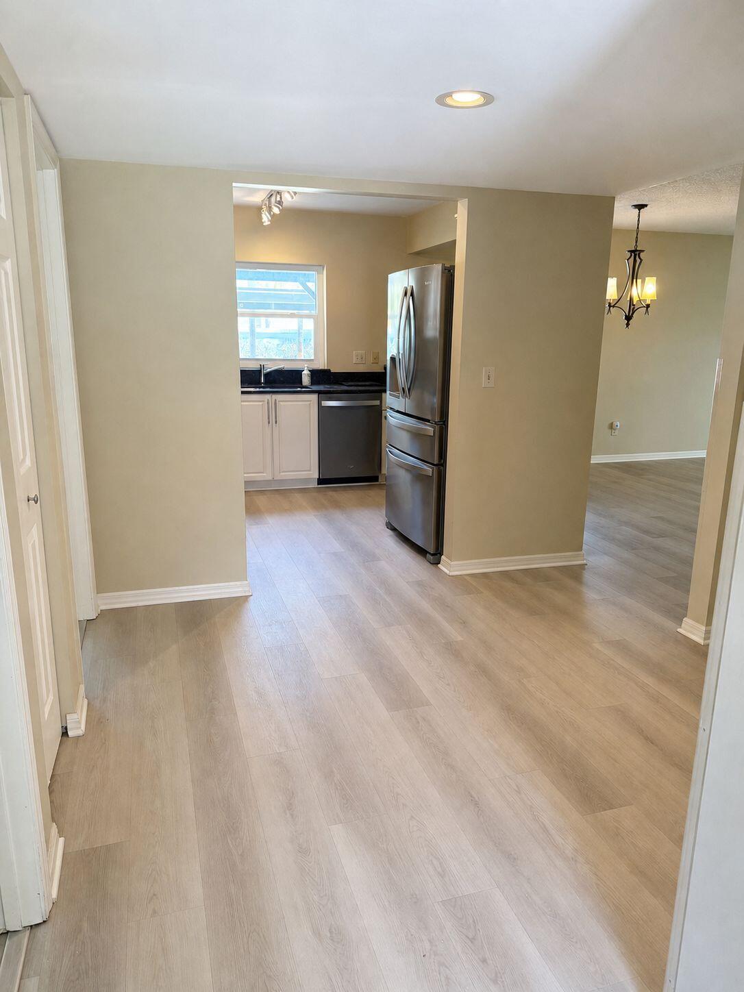 1871 Southwest Palm City Road, Unit G401 Stuart, FL 34994 - Photo 5 of 16 a view of a kitchen cabinets and wooden floor
