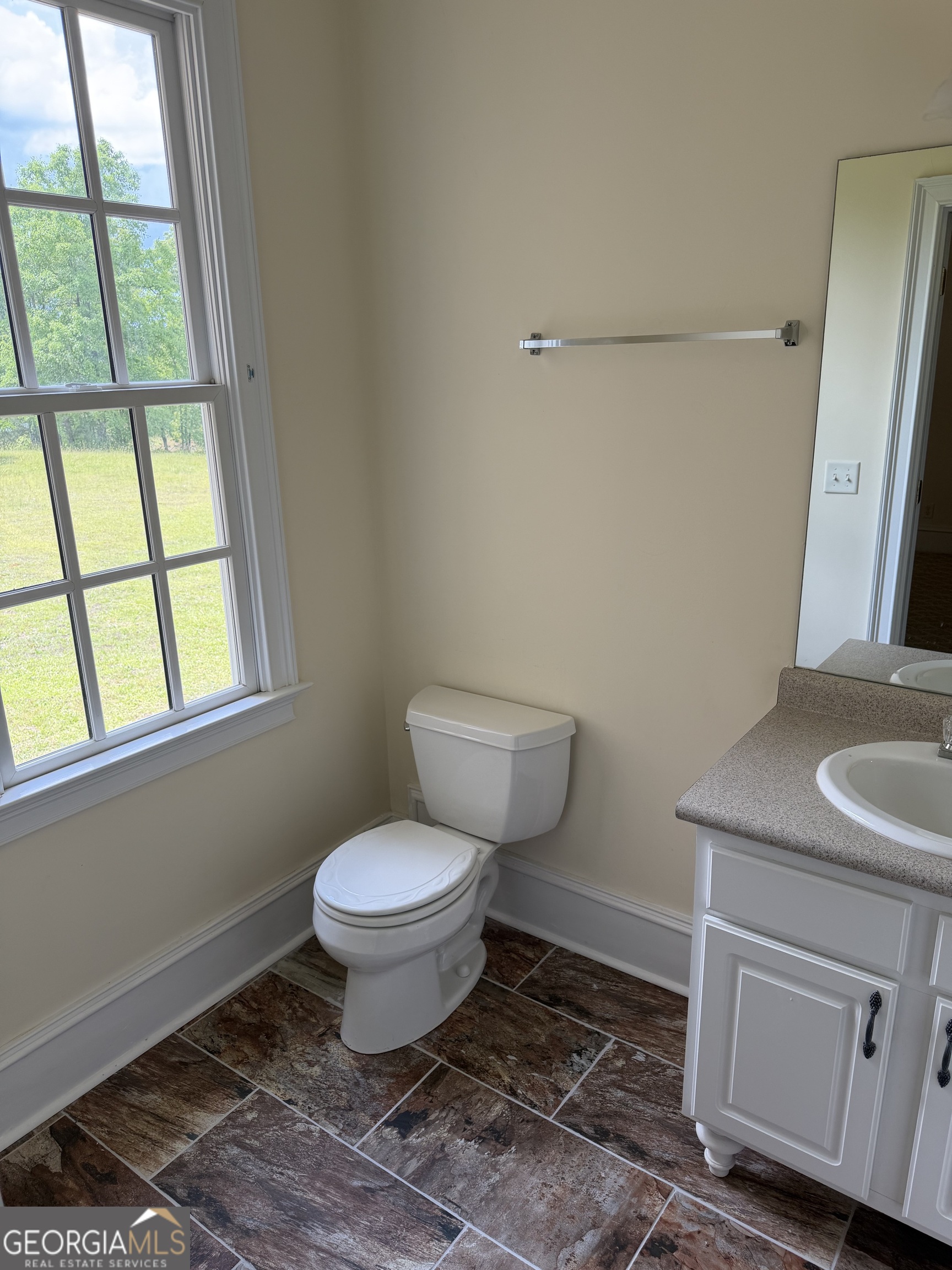 302 Norris Road Barnesville, GA 30204 - Photo 31 of 65 a bathroom with a toilet sink and window