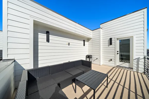 a view of a patio with a table and chairs