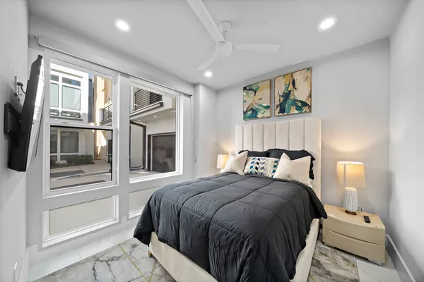 a bedroom with a large bed and a window
