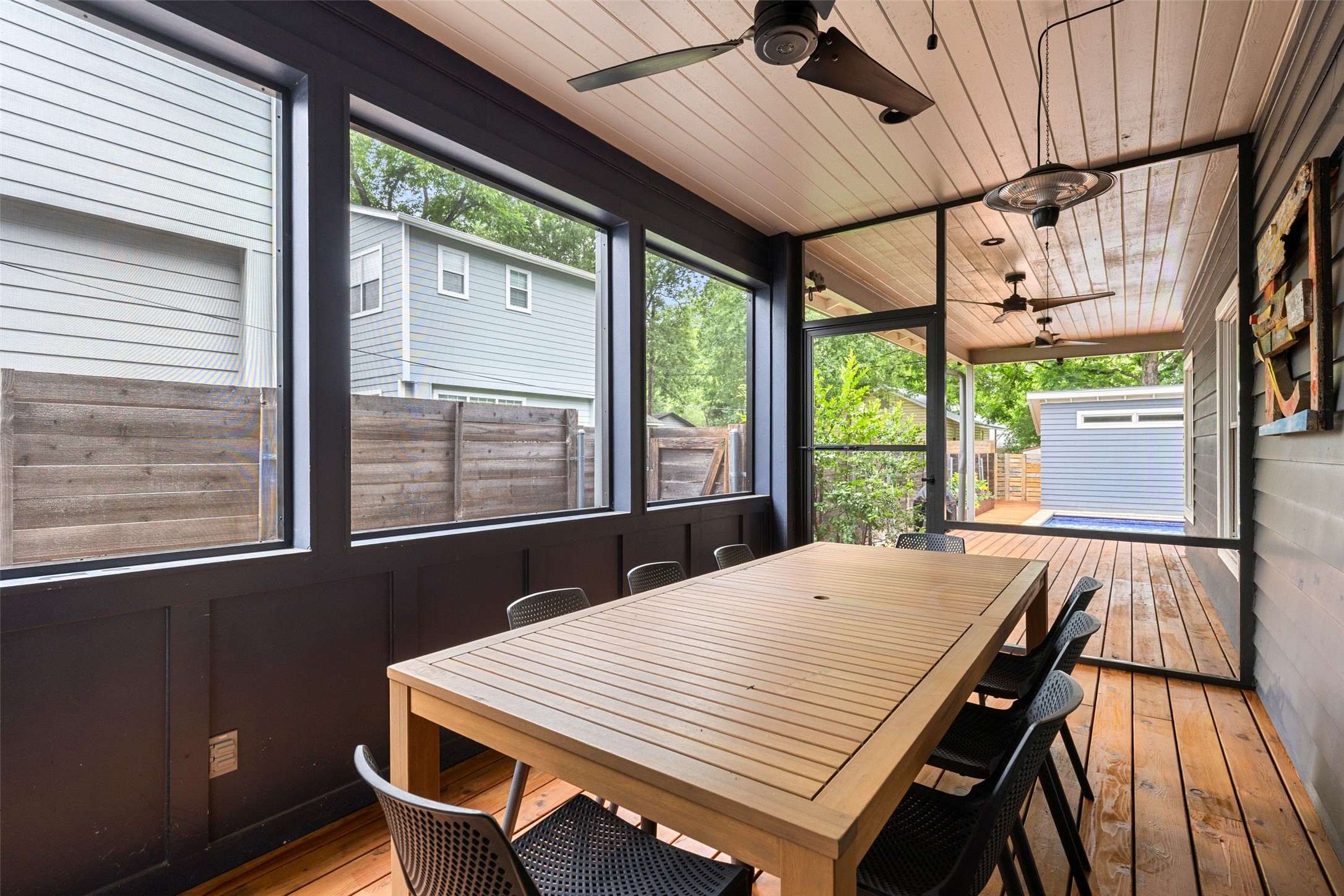 2000 Rundell Place Austin, TX 78704 - Photo 15 of 38 A spacious screened-in porch with wooden floors, offering comfortable outdoor dining and leisure.