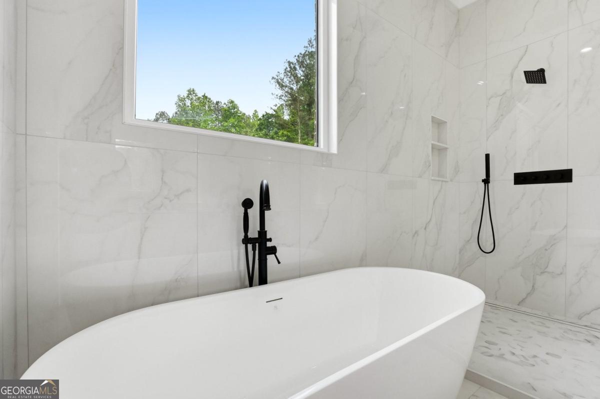 1557 Whitley Road Dacula, GA 30019 - Photo 25 of 46 a white bath tub sitting next to a shower
