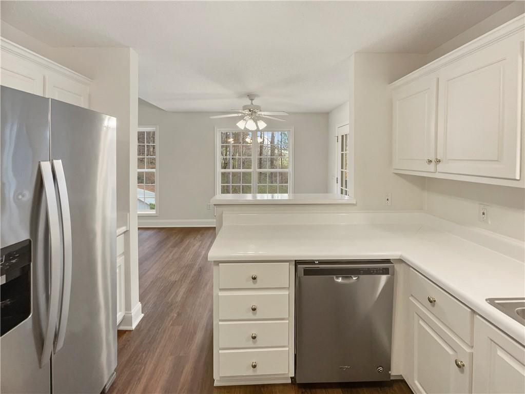 185 Thrasher Lane Jasper, GA 30143 - Photo 12 of 32 a kitchen with white cabinets and refrigerator