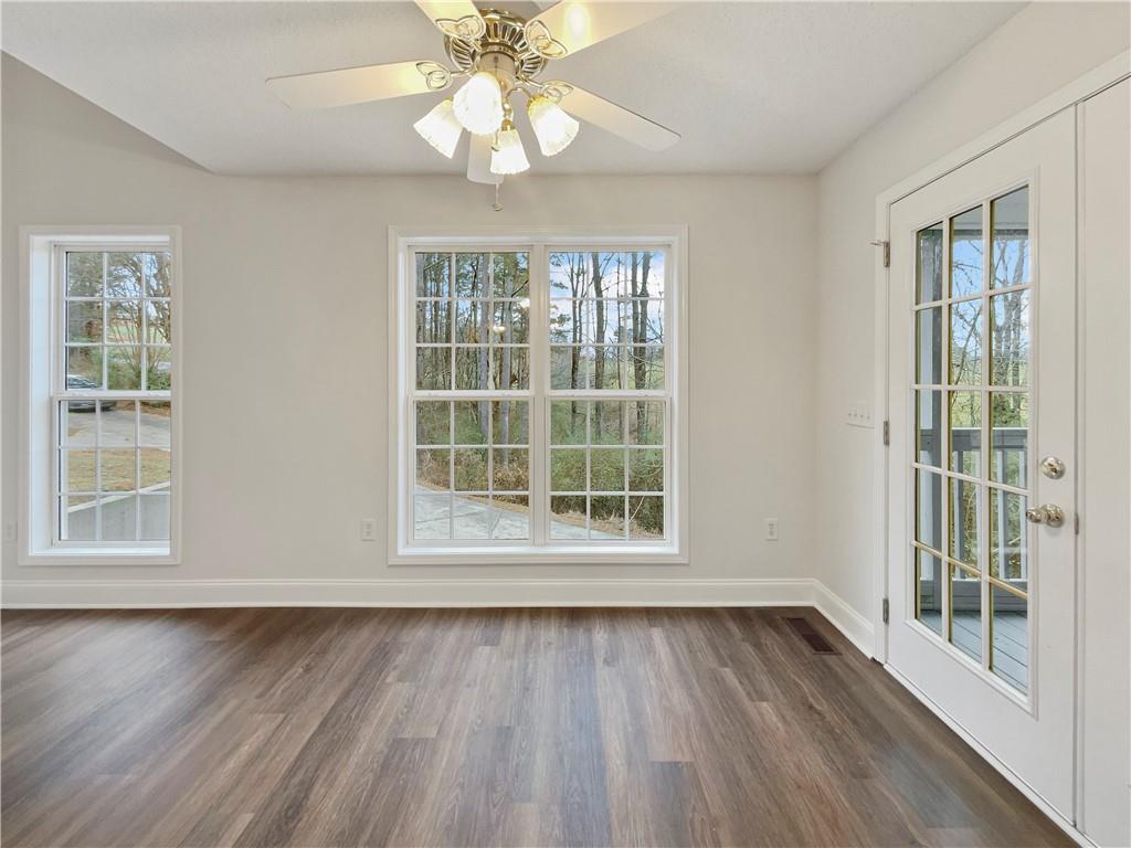 185 Thrasher Lane Jasper, GA 30143 - Photo 15 of 32 a view of an empty room with wooden floor and a window