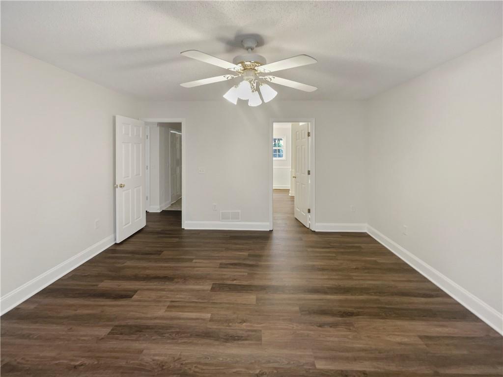 185 Thrasher Lane Jasper, GA 30143 - Photo 21 of 32 a view of a room with wooden floor and ceiling fan