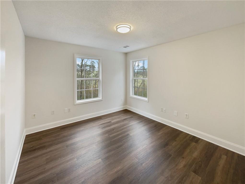 185 Thrasher Lane Jasper, GA 30143 - Photo 22 of 32 an empty room with wooden floor and windows