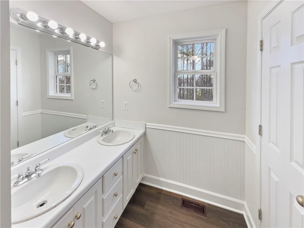 185 Thrasher Lane Jasper, GA 30143 - Photo 25 of 32 a bathroom with a double vanity sink and a mirror