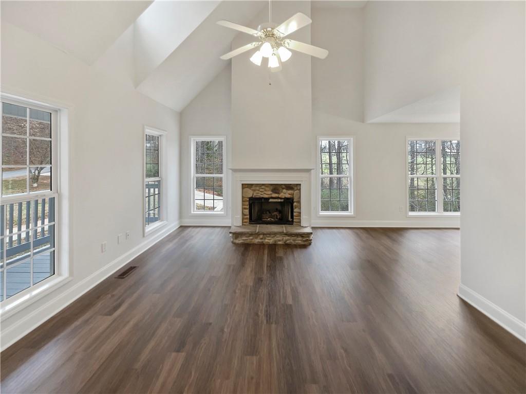 185 Thrasher Lane Jasper, GA 30143 - Photo 5 of 32 a view of a livingroom with wooden floor fireplace and a window