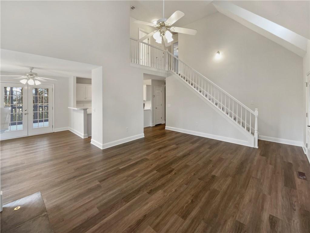 185 Thrasher Lane Jasper, GA 30143 - Photo 8 of 32 a view of an empty room with wooden floor and a ceiling fan