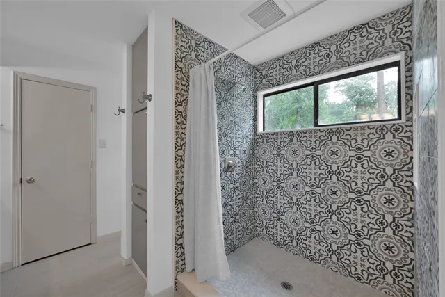 a bathroom with a shower and a sink