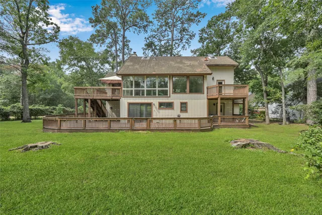 a view of a house with a yard deck and sitting area