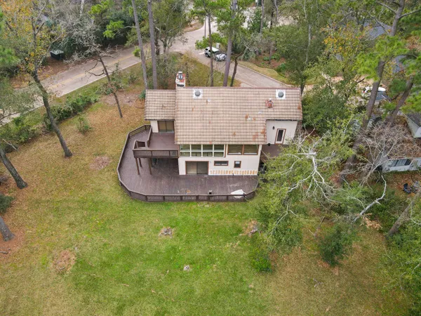 an aerial view of a house with a garden and trees