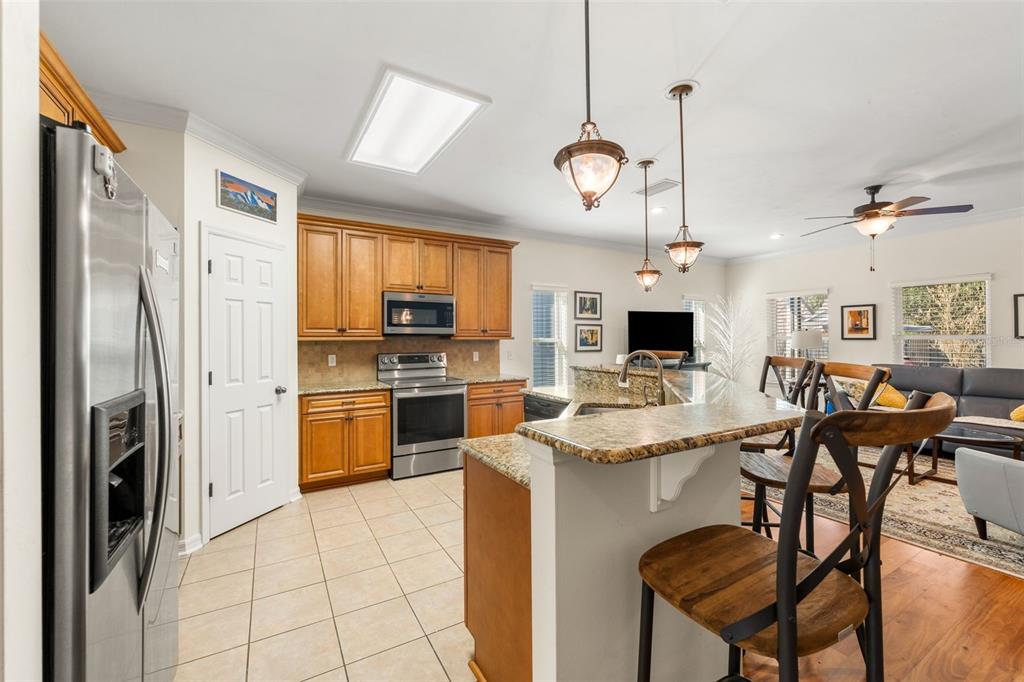 7638 Southwest 80th Drive Gainesville, FL 32608 - Photo 11 of 48 a kitchen with stainless steel appliances granite countertop a stove refrigerator and a sink