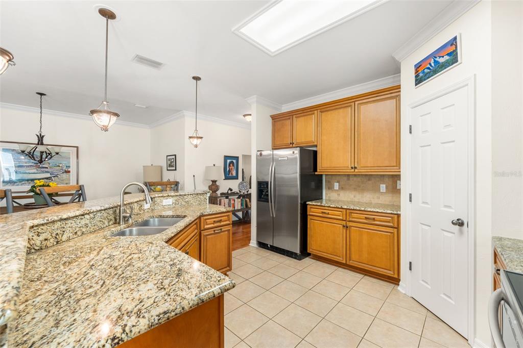 7638 Southwest 80th Drive Gainesville, FL 32608 - Photo 14 of 48 a kitchen with stainless steel appliances granite countertop a refrigerator a stove and a sink with cabinets