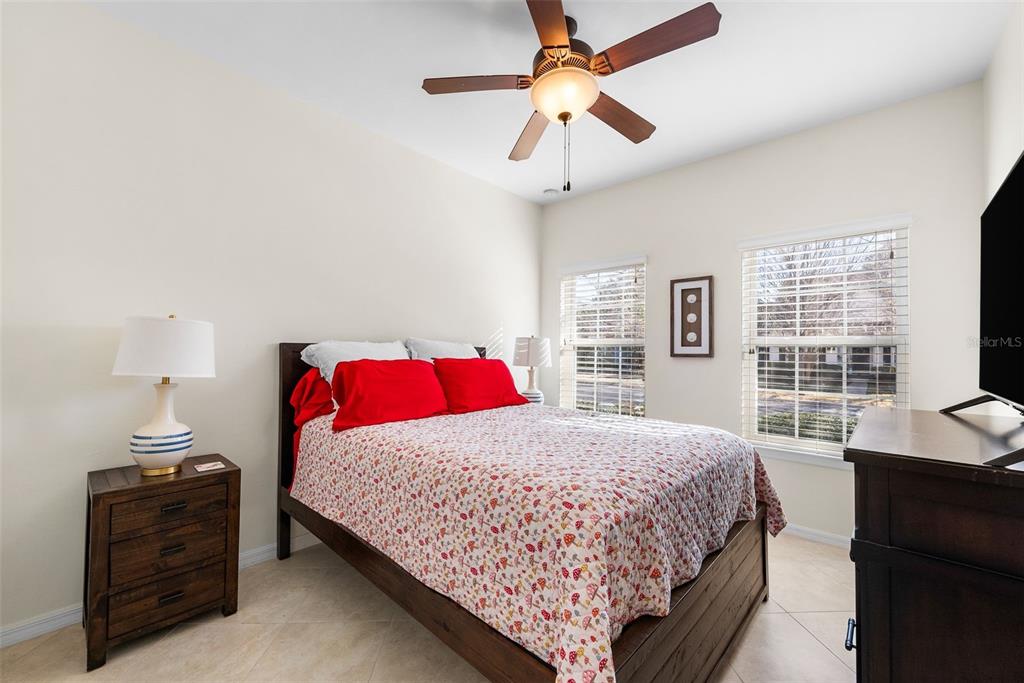 7638 Southwest 80th Drive Gainesville, FL 32608 - Photo 19 of 48 a bedroom with a bed chandelier and a window