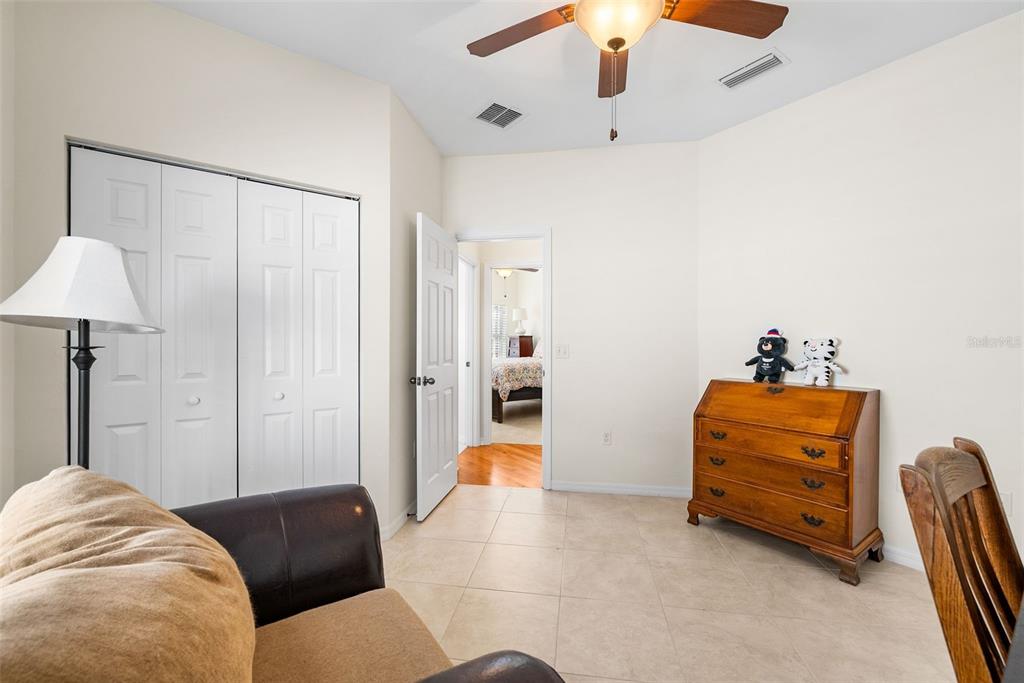 7638 Southwest 80th Drive Gainesville, FL 32608 - Photo 21 of 48 a bedroom with furniture and a chandelier