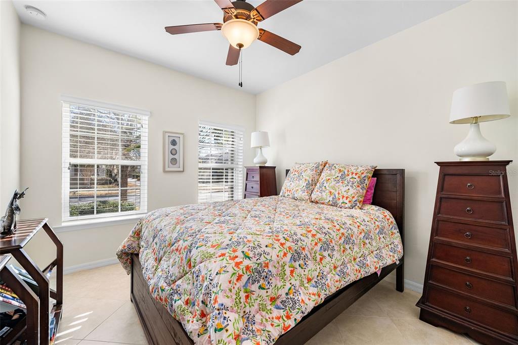 7638 Southwest 80th Drive Gainesville, FL 32608 - Photo 22 of 48 a bedroom with a bed and wooden floor